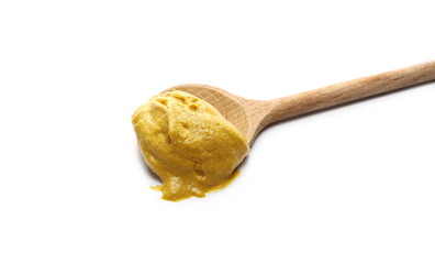 Yellow mustard sauce with wooden spoon isolated on white background