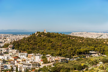 Athens city panorama with buildings standing close to each other and aegean see on horizon.