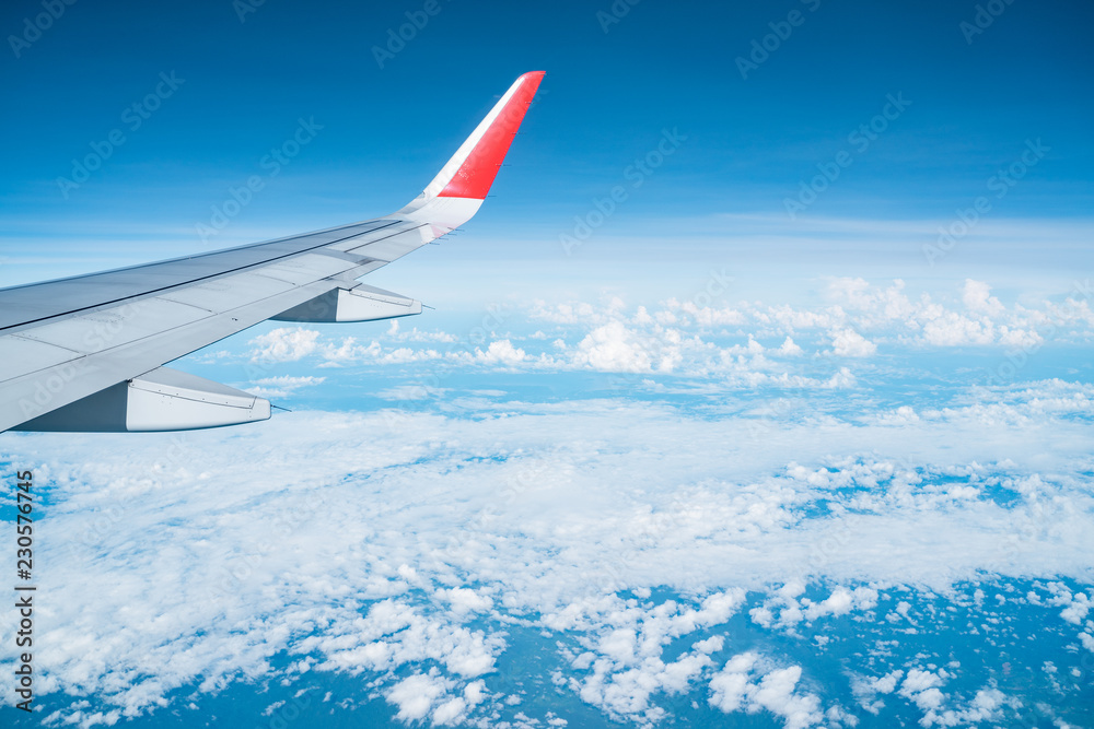 Wall mural Beautiful view from airplane window and blue sky on nice sunny day, This time in altitude during flight.