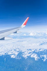 Beautiful view from airplane window and blue sky on nice sunny day, This time in altitude during flight.