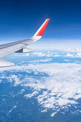 Fototapeta premium Beautiful view from airplane window and blue sky on nice sunny day, This time in altitude during flight.