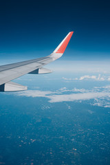 Beautiful view from airplane window and blue sky on nice sunny day, This time in altitude during flight.