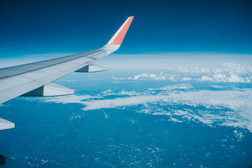 Beautiful view from airplane window and blue sky on nice sunny day, This time in altitude during flight.