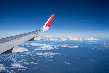 Fototapeta na wymiar Beautiful view from airplane window and blue sky on nice sunny day, This time in altitude during flight.