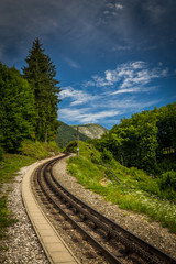Fototapeta na wymiar Alpine rack railway track to Schafberg, where steam train takes tourists on a mountain peak in the Austrian Alps near Salzburg