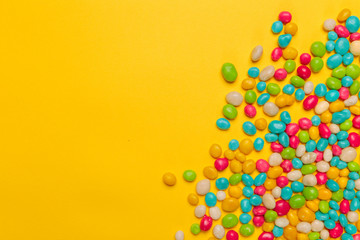 colored candies on yellow background