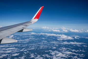 Beautiful view from airplane window and blue sky on nice sunny day, This time in altitude during flight.