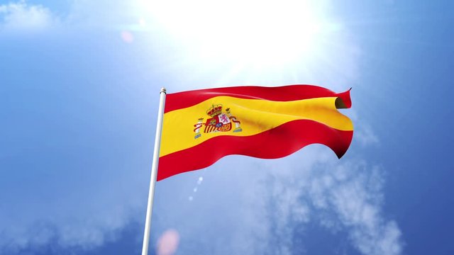The national flag of Spain waving in the wind on a sunny day.  Beautiful slow motion shot of the Spanish flag.