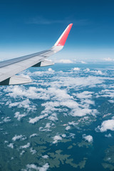 Fototapeta premium Beautiful view from airplane window and blue sky on nice sunny day, This time in altitude during flight.