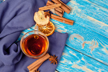 Cup with aromatic hot cinnamon tea on wooden table