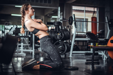 Fototapeta na wymiar Cinematic tone of young attractive fitness woman exercise with machine in gym. Individual sport to fit muscles of body for healthy life concept. 