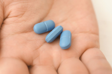 Pills om male hand, closeup