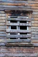 Boarded up windows of abandoned rural house