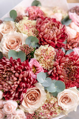 Beautiful spring bouquet in glass vase. Arrangement with various flowers. The concept of a flower shop. A set of photos for a site or catalogue. Work florist.