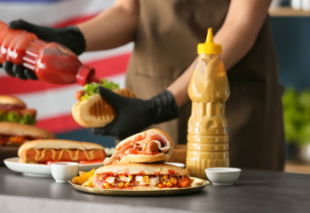 Tasty hot dogs on metal tray indoors