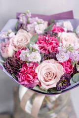 Beautiful spring bouquet in glass vase. Arrangement with various flowers. The concept of a flower shop. A set of photos for a site or catalogue. Work florist.