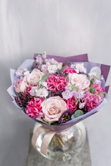 Beautiful spring bouquet in glass vase. Arrangement with various flowers. The concept of a flower shop. A set of photos for a site or catalogue. Work florist.