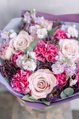 Beautiful spring bouquet in glass vase. Arrangement with various flowers. The concept of a flower shop. A set of photos for a site or catalogue. Work florist.