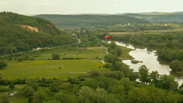 Paragliding in the Carpathians.
Red paraplane fly over valley.
Magic Lantern Raw Video