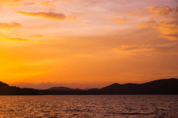 Vivid beautiful sunset and sunrise sky reflection on sea wave.