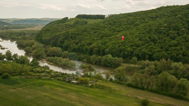 Paragliding in the Carpathians.
Red paraplane fly over valley.
Magic Lantern Raw Video