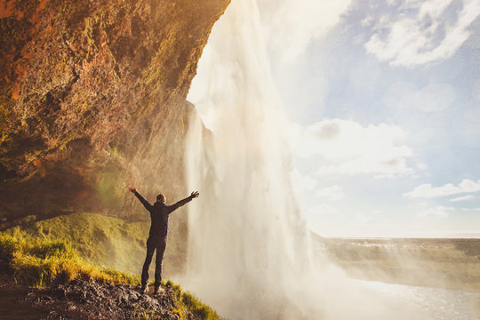 Fototapeta inspiring travel landscape, person standing near beautiful waterfall in Iceland