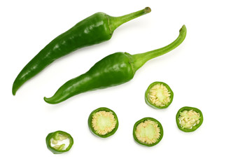sliced green hot chili peppers isolated on white background top view