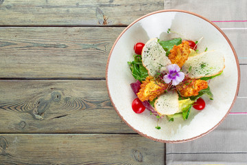 Fresh salad with chicken breast, arugula and tomato. Top view