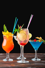 Alcoholic and non alcoholic cocktails on wooden table. Summer cold drinks