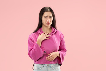 Fototapeta premium Why is that. Beautiful female half-length portrait isolated on trendy pink studio backgroud. Young emotional surprised, frustrated and bewildered woman. Human emotions, facial expression concept.