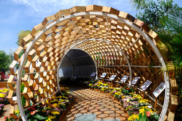 Shading walkway made of wood in the shape of a hexagon at Floria Garden in Putrajaya, Malaysia. The...