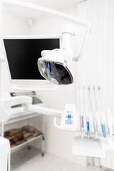 Modern led lamp in the dentists clinic. Dental work in clinic. Operation, tooth replacement. Medicine, health, stomatology concept. Office where dentist conducts inspection and concludes.