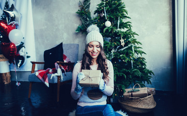 christmas, x-mas, winter, happiness concept - smiling woman with gift box.