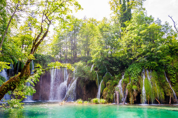 Mountains lake with waterfall surrounded by forest in Plitvice Lakes National Park, Croatia