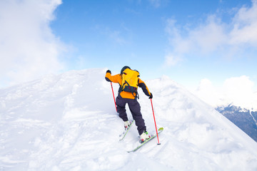 Naklejka na ściany i meble Man skiing in the mountains