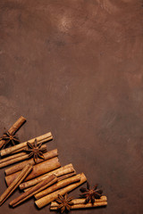 Brown sugar, cinnamon sticks and star anise on wooden background
