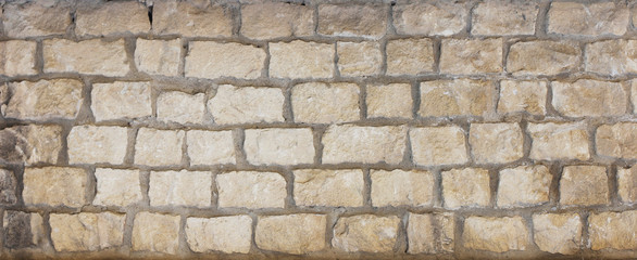 Old wall background from natural stones bricks and concrete. 