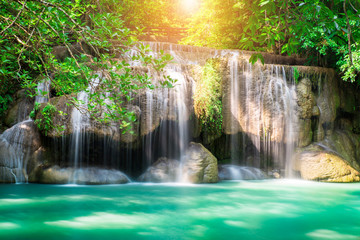 Fototapeta na wymiar Erawan waterfall at tropical forest of national park, Thailand 