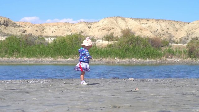 the child stands at the lake