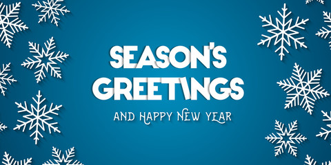 Season's Greetings and Happy New Year greeting card concept with white snowflakes and blue background © lvnl