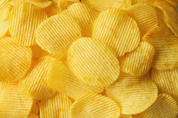 crispy potato chips snack texture background closeup top view
