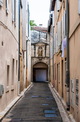 Medieval Avignon Old Town street with arc entrance in the end