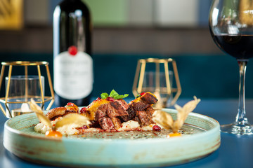 Delicious breast duck with mash potato and red wine on the table. Fine cuisine