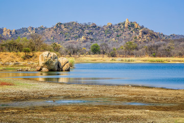 View of a lake surrounded by rocks, in Matobo National Park, Zimbabwe. September 26, 2016.