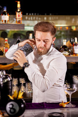The bartender prepares a cocktail in the