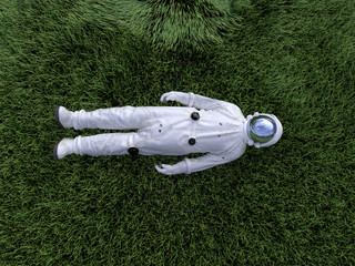 astronaut lying on the green grass © Photobank