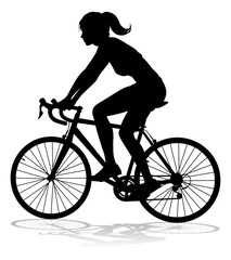Fototapeta premium A woman bicycle riding bike cyclist in silhouette