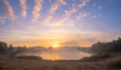 Beautiful misty sunrise over the lake
