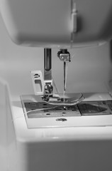 Needle closeup electric sewing machine black-and-white image