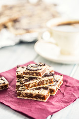 A waffle cake with caramel chocolate and walnuts.Traditional slovak and czech cake grilaz with coffee